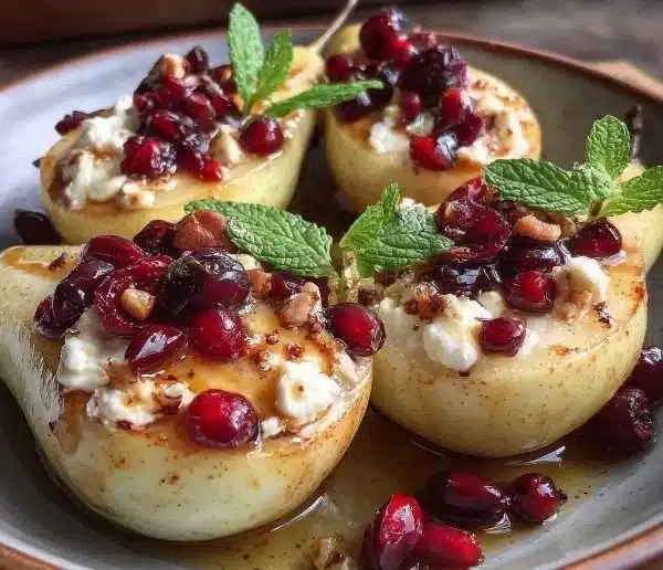 Baked pears with goat cheese, honey, and cranberries garnished on a plate
