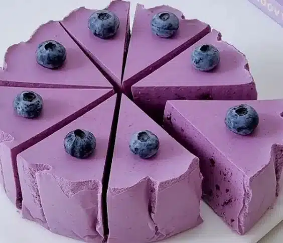 Delicious blueberry yogurt mousse cake topped with fresh blueberries
