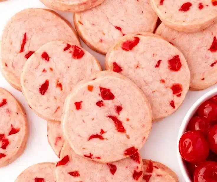 Cherry almond shortbread cookies stacked on a plate, ideal for dessert or tea time.