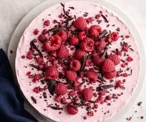 Delicious slice of Chocolate Raspberry Mousse Cake with fresh raspberries