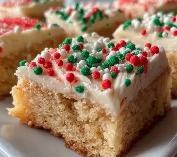 Festive Christmas sugar cookie bars decorated with holiday sprinkles
