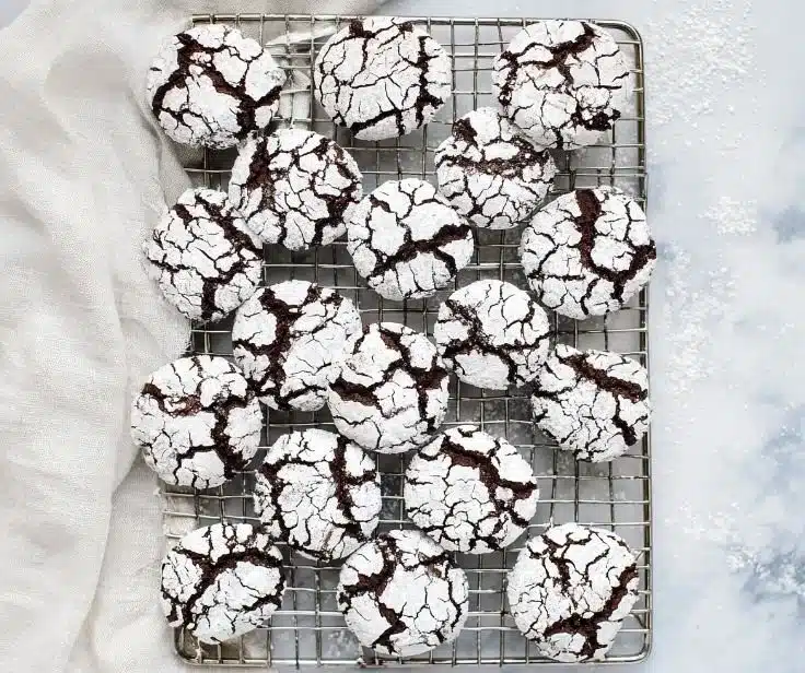 Gluten-free chocolate crinkle cookies with a fudgy texture and powdered sugar topping