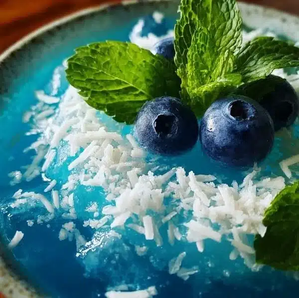 Festive Jack Frost Mimosas with cranberry and orange garnishes