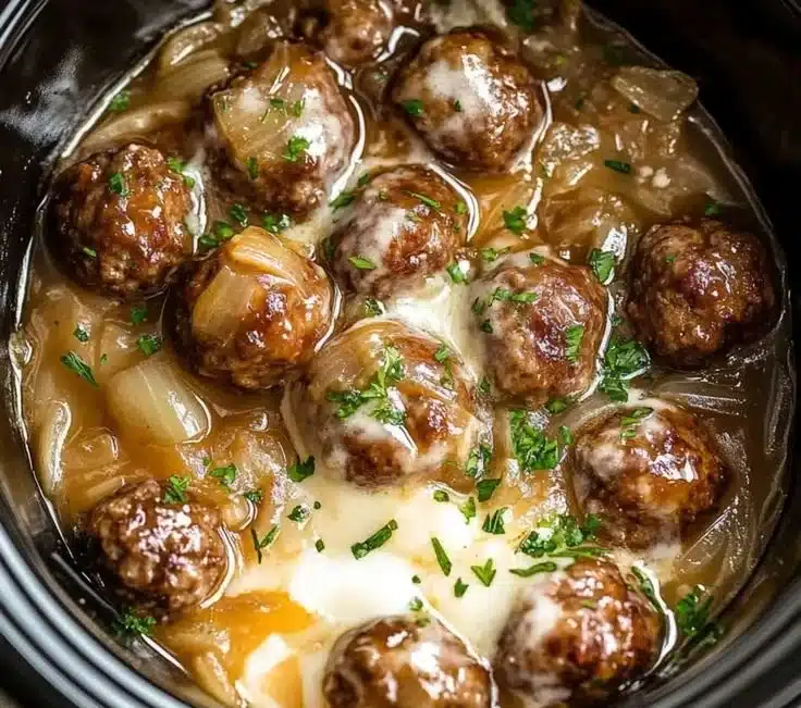 Crock pot French onion meatballs served in a savory onion sauce