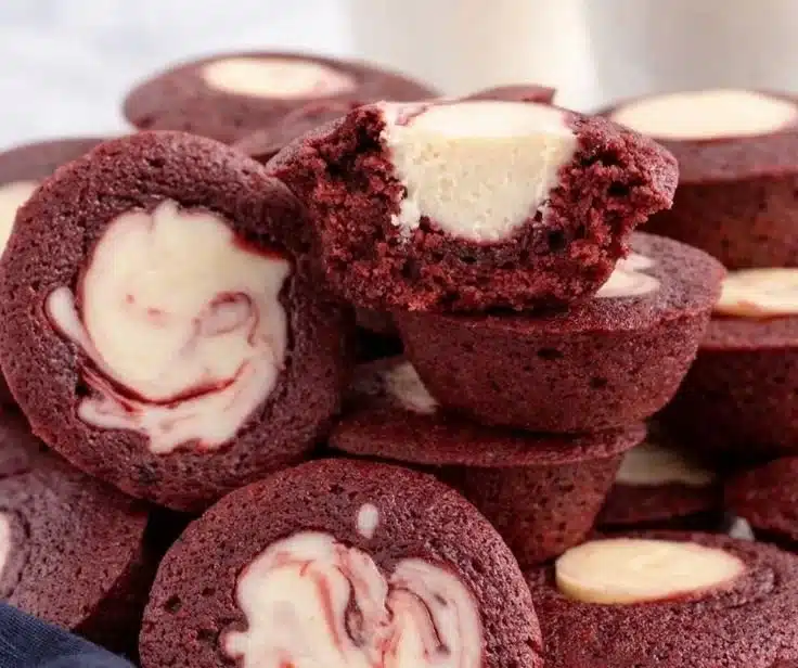 Delicious mini red velvet cheesecakes topped with cream cheese frosting