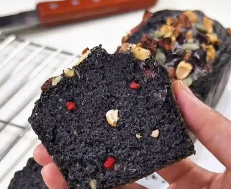 Black sesame whole wheat pound cake on a rustic wooden table