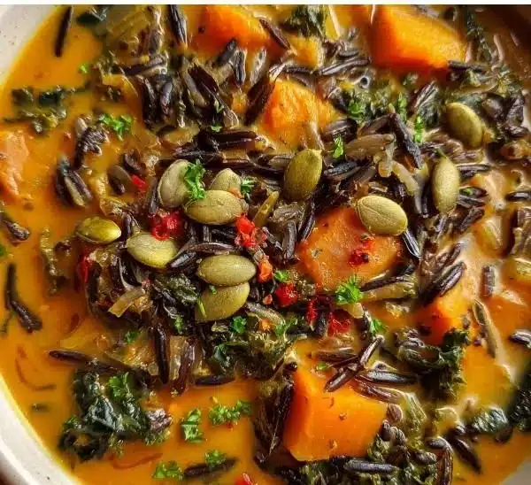 Nourishing Vegan Pumpkin Wild Rice Soup 4 Vegan pumpkin wild rice soup in a bowl garnished with herbs.
