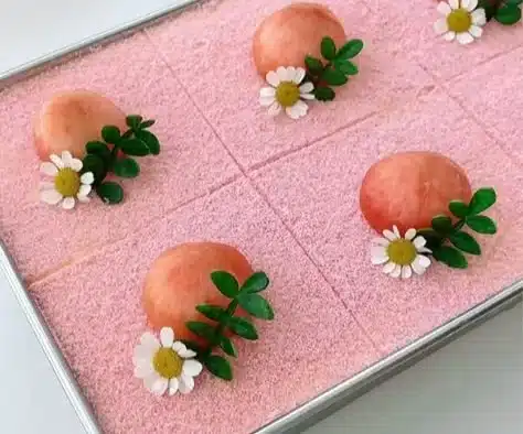 Peach Oolong Tiramisu 5 Delicious Peach Oolong Tiramisu dessert with layers of tea-infused cream and peaches.