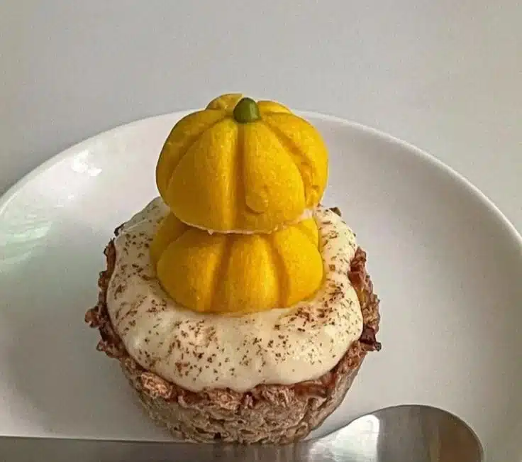 Freshly baked Pumpkin Oat Tart topped with spices and nuts, celebrating fall flavors.