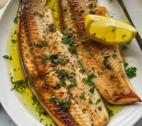Quick garlic butter seared trout with lemon and parsley on a plate