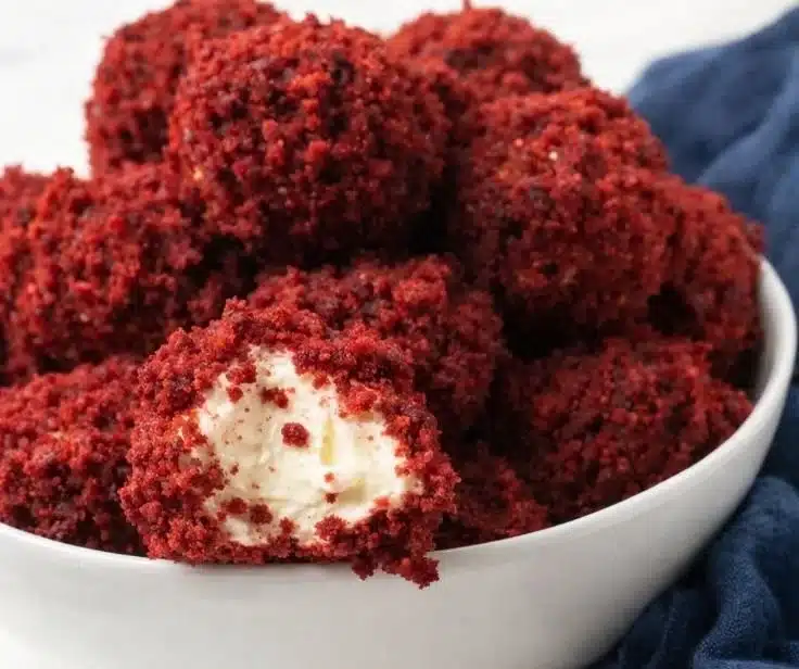 Delicious red velvet cheesecake balls topped with cream cheese frosting