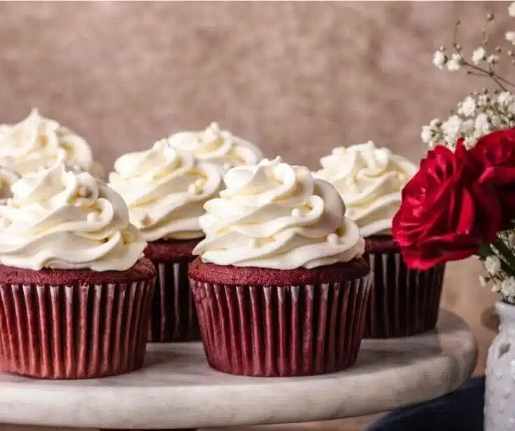 Red Velvet Cupcakes | Amazing Creamy Frosting Recipe 5 Delicious red velvet cupcakes with creamy frosting on a wooden table.