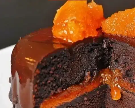 Delicious slice of Sacher Cake with rich chocolate glaze and apricot filling.