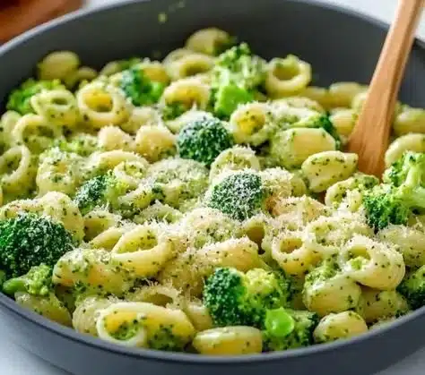 A bowl of light and healthy broccoli pasta with fresh ingredients.