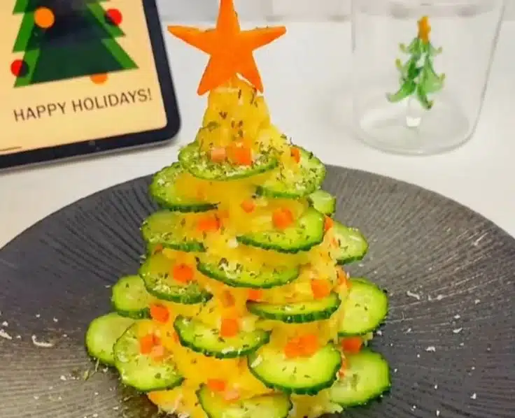 Potato Salad shaped like a Christmas tree, decorated with festive toppings.