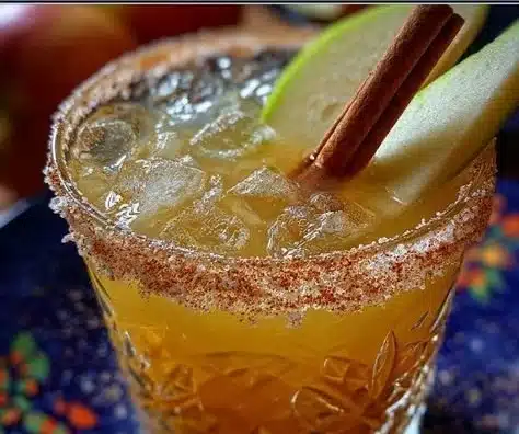 Refreshing Apple Cider Margarita in a glass with apple slices and cinnamon