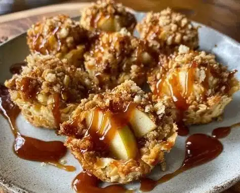 Delicious caramel apple crisp bites topped with caramel sauce and a crunchy topping.