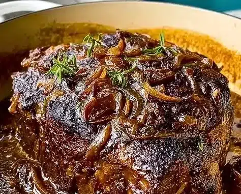 Delicious Caramelized French Onion Pot Roast served in a rustic dish.