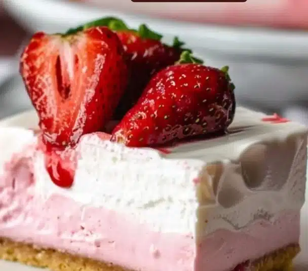 Sparkling strawberry champagne cheesecake bars garnished with fresh strawberries.