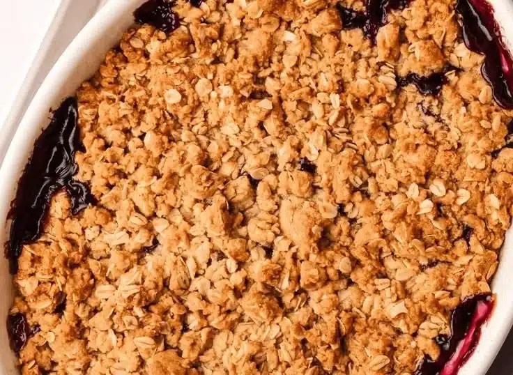 Delicious Apple Blueberry Crisp dessert with a golden brown topping and fresh blueberries.