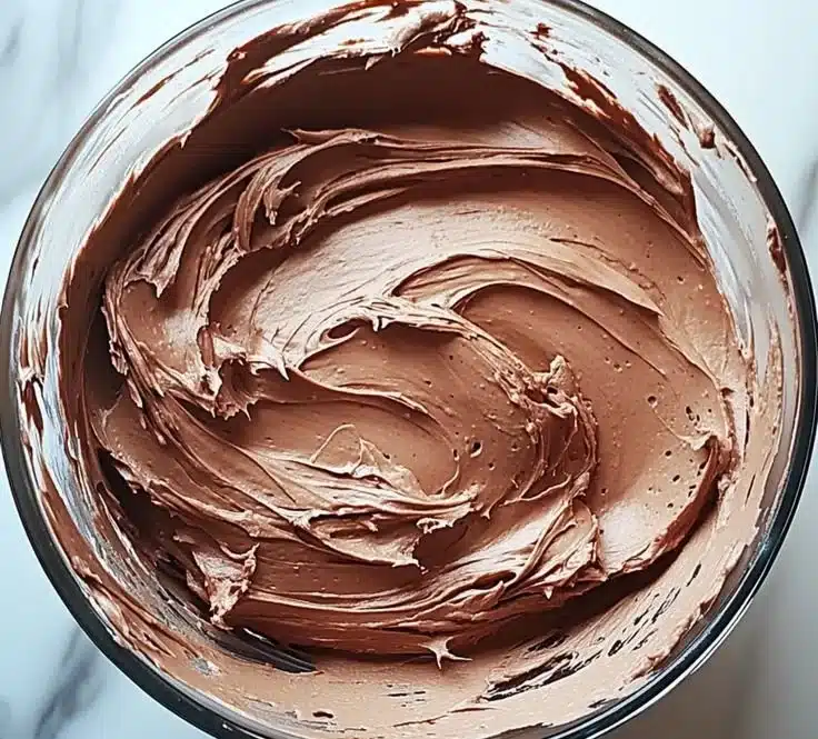 Delicious chocolate buttercream frosting ready to spread on cakes.