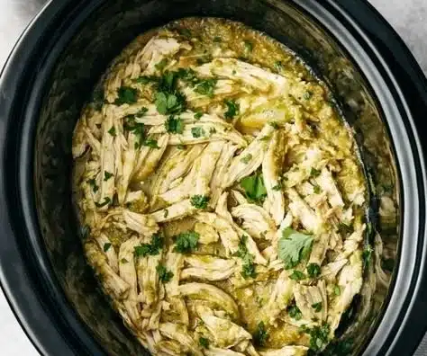Crockpot Salsa Verde Chicken served with fresh herbs and vegetables